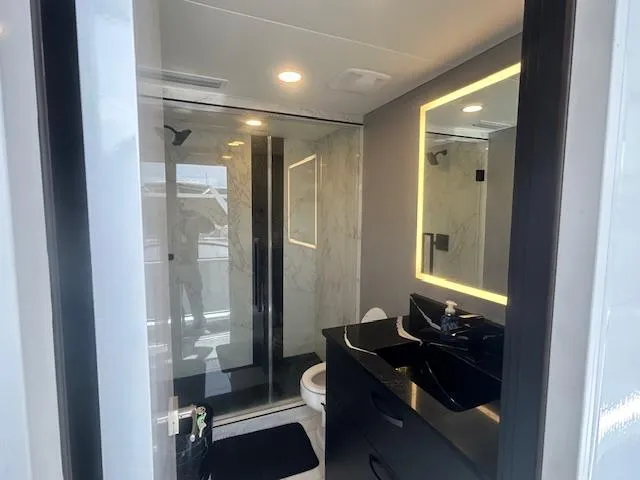 Slide: The Image of Modern bathroom in 2020 Adonia houseboat with sleek black fixtures and illuminated mirror. - 30