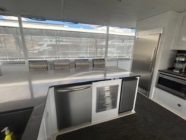 Slide: The Image of Modern kitchen interior on 2020 Adonia houseboat with stainless steel appliances and large windows. - 32