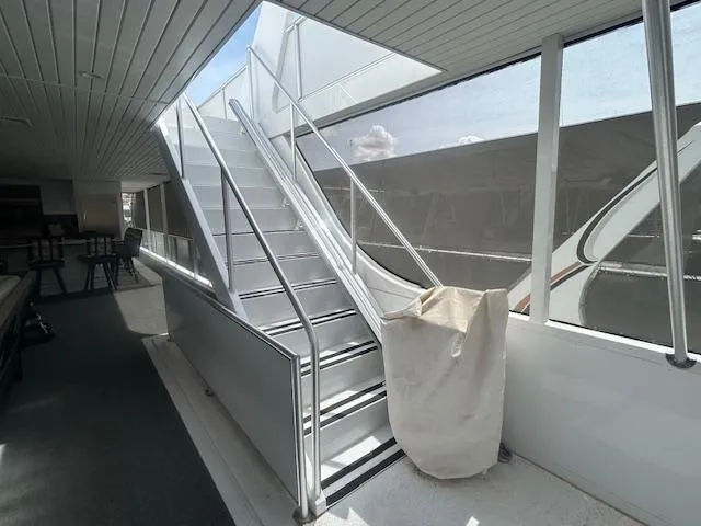 Slide: The Image of Modern Adonia houseboat interior with sleek staircase, spacious design, and natural light. - 33