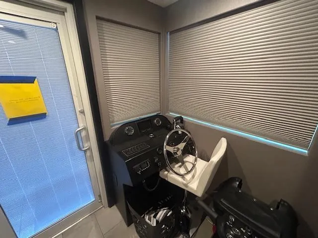 Slide: The Image of Pilot area of a 2020 Adonia houseboat with steering wheel and controls. - 5