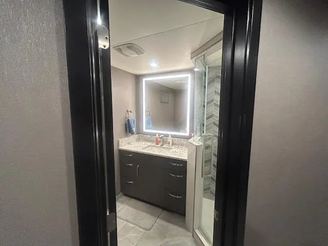 Slide: The Image of Modern bathroom on 2020 Adonia houseboat with illuminated mirror and sleek design. - 7