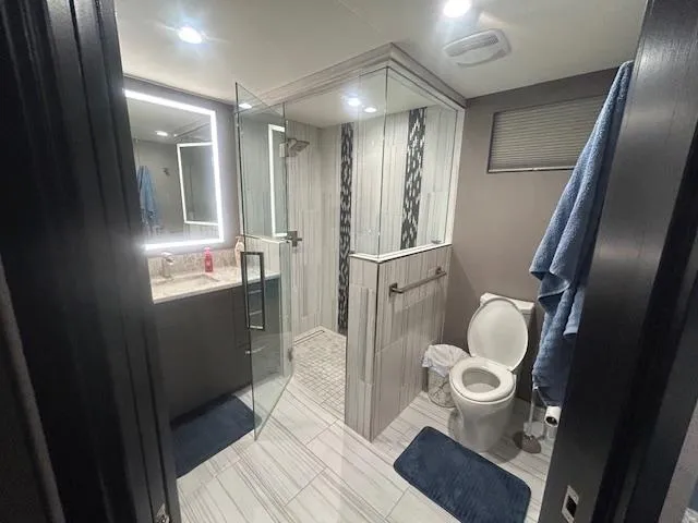 Slide: The Image of Modern bathroom on 2020 Adonia houseboat with glass shower and sleek fixtures. - 9