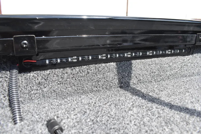 Slide: The Image of 2025 Lowe Stinger 175C boat deck with gray carpet and storage compartments. - 16