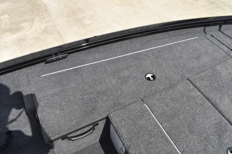Slide: The Image of 2025 Lowe Stinger 175C boat deck with gray carpet and storage compartment. - 17