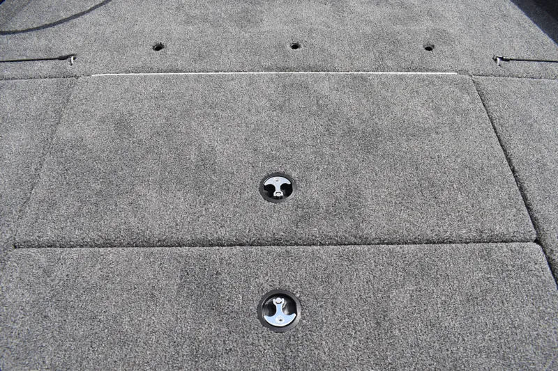 Slide: The Image of 2025 Lowe Stinger 175C boat deck with gray carpet and storage compartments. - 19