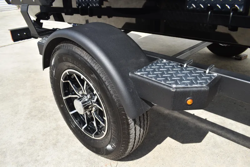 Slide: The Image of 2025 Lowe Stinger 175C fishing boat with Mercury outboard engine on trailer. - 3