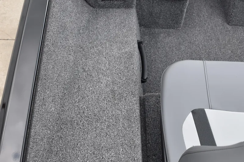 Slide: The Image of 2025 Lowe Stinger 175C boat interior with gray seating and carpeted flooring. - 31