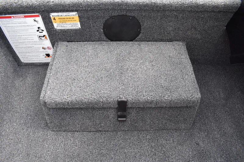 Slide: The Image of 2025 Lowe Stinger 175C boat interior with storage compartment and safety labels. - 32