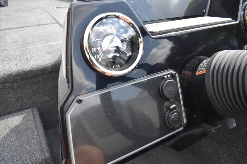 Slide: The Image of 2025 Lowe Stinger 175C boat interior with steering wheel and storage compartments. - 35