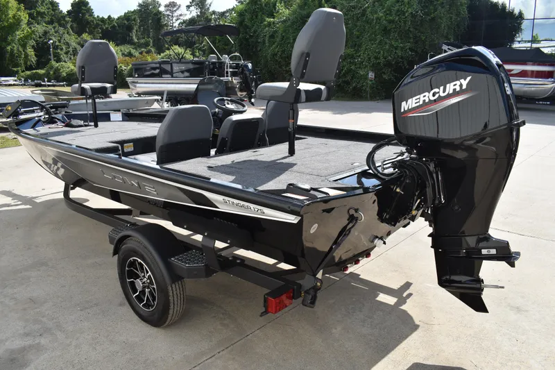 Slide: The Image of 2025 Lowe Stinger 175C boat deck with gray carpet and storage compartments. - 9