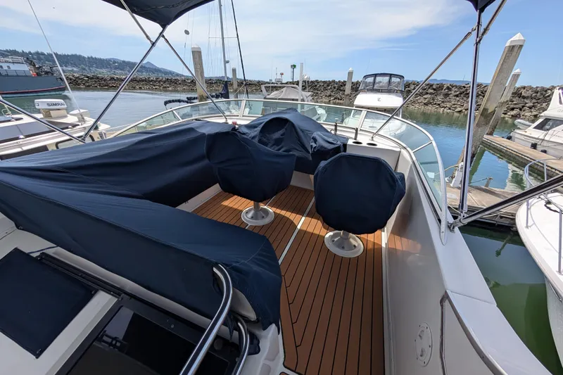 Slide: The Image of Bayliner 4088 yacht, 2000 model, docked with covered seating and wooden deck. - 12