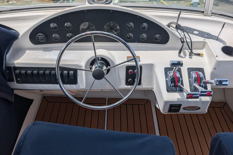 Slide: The Image of 2000 Bayliner 4088 helm with steering wheel, control panel, and throttle levers. - 14