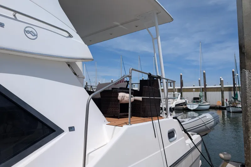 Slide: The Image of Bayliner 4088 yacht, 2000 model, docked at marina with outdoor seating area. - 3