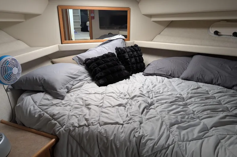 Slide: The Image of Cozy bedroom in 2000 Bayliner 4088 yacht with plush bedding and pillows. - 38