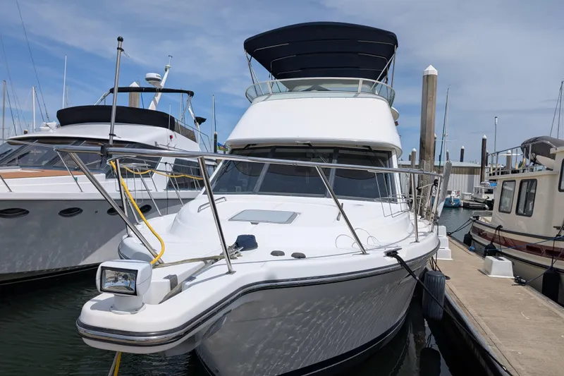 Slide: The Image of 2000 Bayliner 4088 yacht docked at marina under clear blue sky. - 1