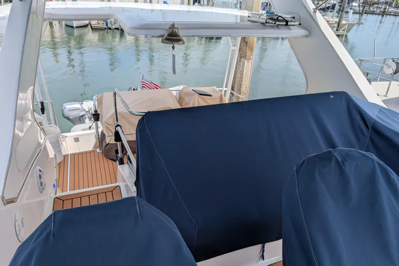 Slide: The Image of 2000 Bayliner 4088 yacht with blue covers, docked at marina. - 13