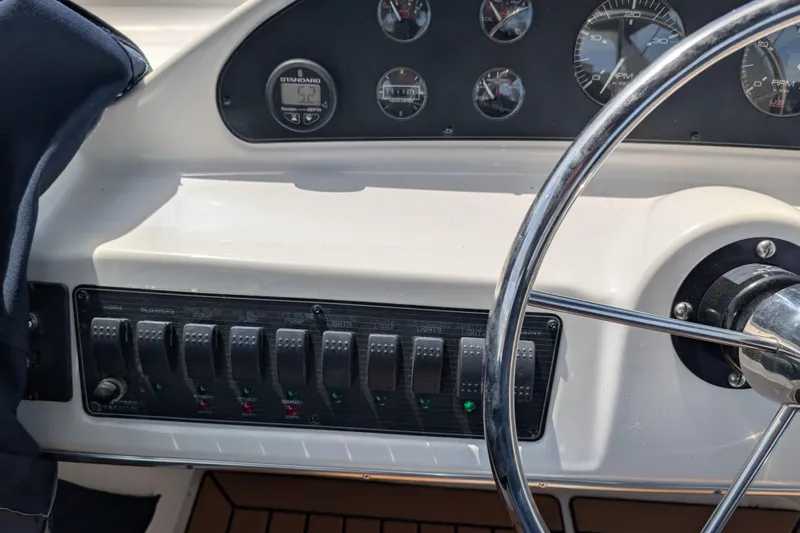 Slide: The Image of Dashboard of a 2000 Bayliner 4088 boat with steering wheel and control panel. - 16