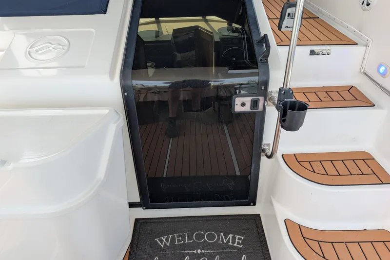 Slide: The Image of Bayliner 4088 yacht entrance with welcome mat, teak steps, and glass door, 2000 model. - 20