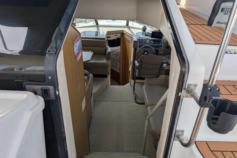 Slide: The Image of Interior view of a 2000 Bayliner 4088 boat, featuring helm and seating area. - 21