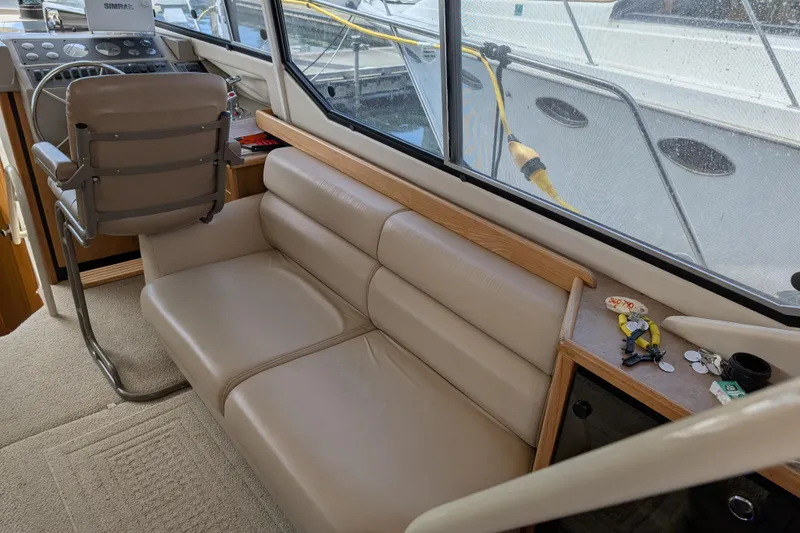 Slide: The Image of Interior of 2000 Bayliner 4088 yacht with beige seating and helm station. - 22