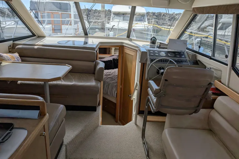 Slide: The Image of Interior of 2000 Bayliner 4088 yacht with seating, table, and helm station. - 23