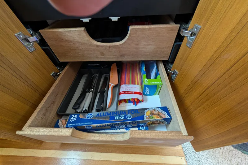 Slide: The Image of Drawer in 2000 Bayliner 4088 yacht with utensils, aluminum foil, and plastic wrap. - 28