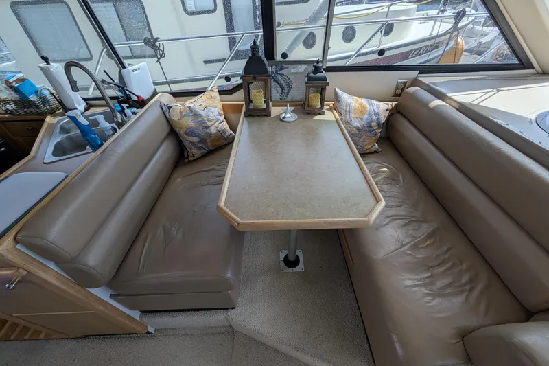 Slide: The Image of Interior of 2000 Bayliner 4088 yacht with cozy dining area and leather seating. - 29