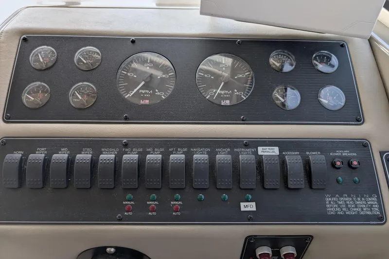 Slide: The Image of Control panel of a 2000 Bayliner 4088 boat, featuring gauges and switches. - 32