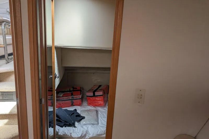 Slide: The Image of Interior cabin of 2000 Bayliner 4088 with life jackets and bedding. - 40