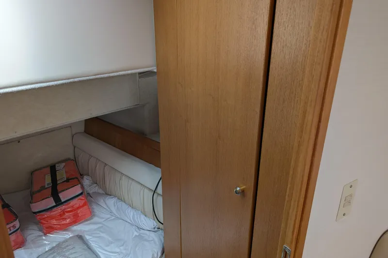 Slide: The Image of Interior cabin of 2000 Bayliner 4088 with life jackets on bed. - 41