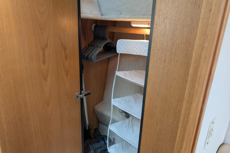 Slide: The Image of Bayliner 4088 2000 model closet with hangers and storage shelves. - 42