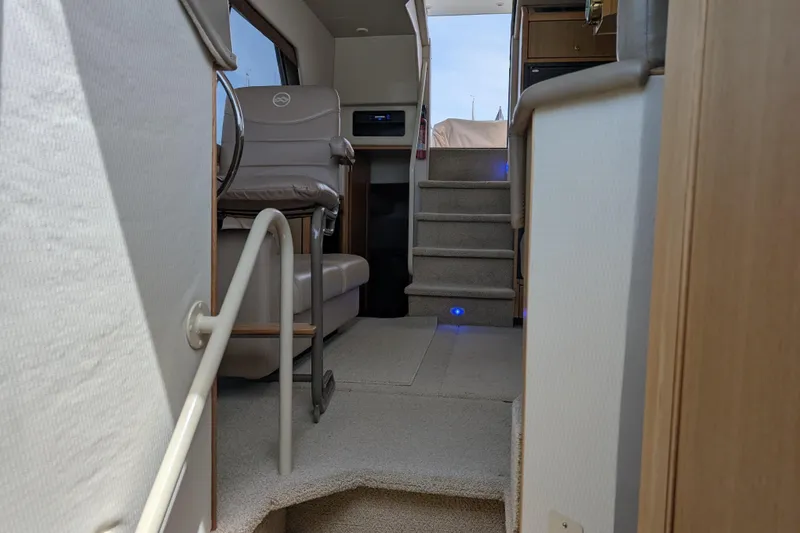 Slide: The Image of Interior view of 2000 Bayliner 4088 yacht, featuring stairs and seating area. - 45