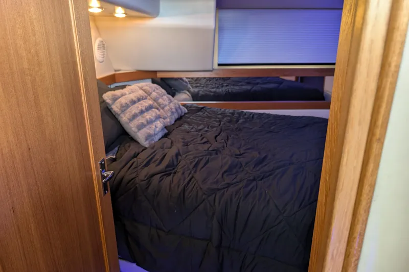 Slide: The Image of Cozy bedroom in 2000 Bayliner 4088 yacht with plush bedding and ambient lighting. - 48