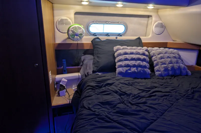 Slide: The Image of Cozy bedroom in 2000 Bayliner 4088 yacht with plush pillows and ambient lighting. - 49
