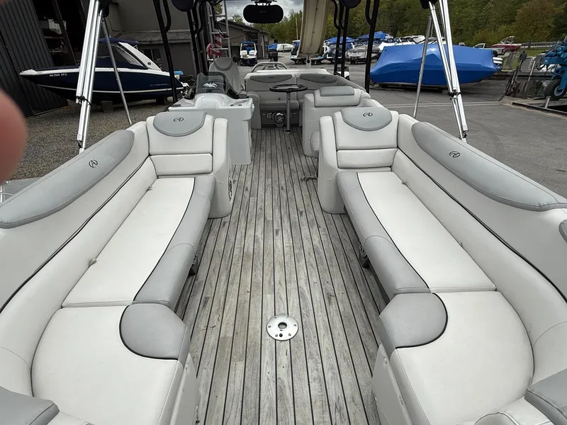 Slide: The Image of 2015 Avalon Paradise Funship 27' pontoon boat with spacious seating and sleek design. - 2