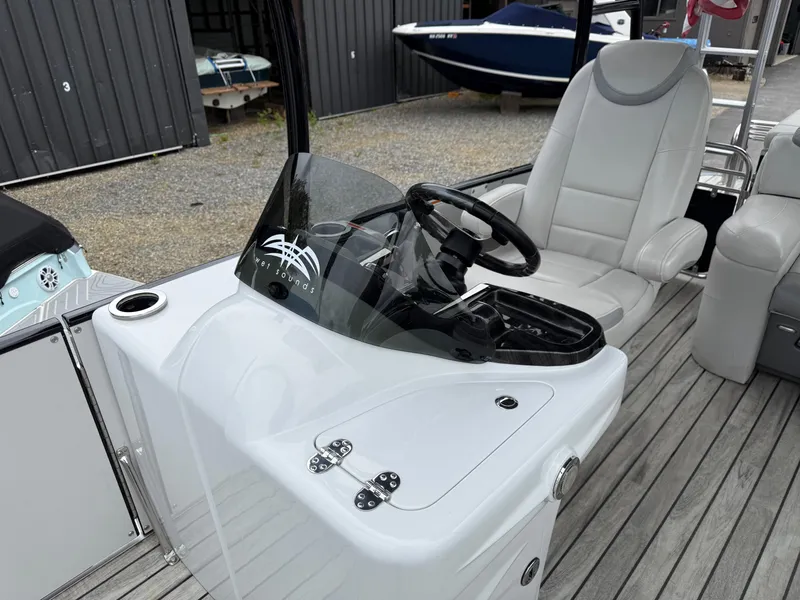 Slide: The Image of 2015 Avalon Paradise Funship boat interior with steering console and seating. - 4