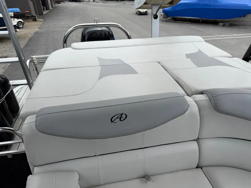 Slide: The Image of 2015 Avalon Paradise Funship 27' boat with cushioned seating and sleek design. - 7