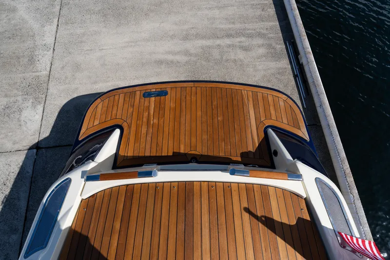 Slide: The Image of 2022 Chris-Craft Launch 27 boat with wooden deck at dockside. - 2