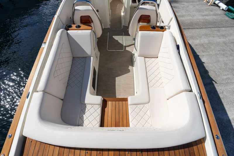 Slide: The Image of 2022 Chris-Craft Launch 27 boat interior with elegant white seating and wooden flooring. - 3