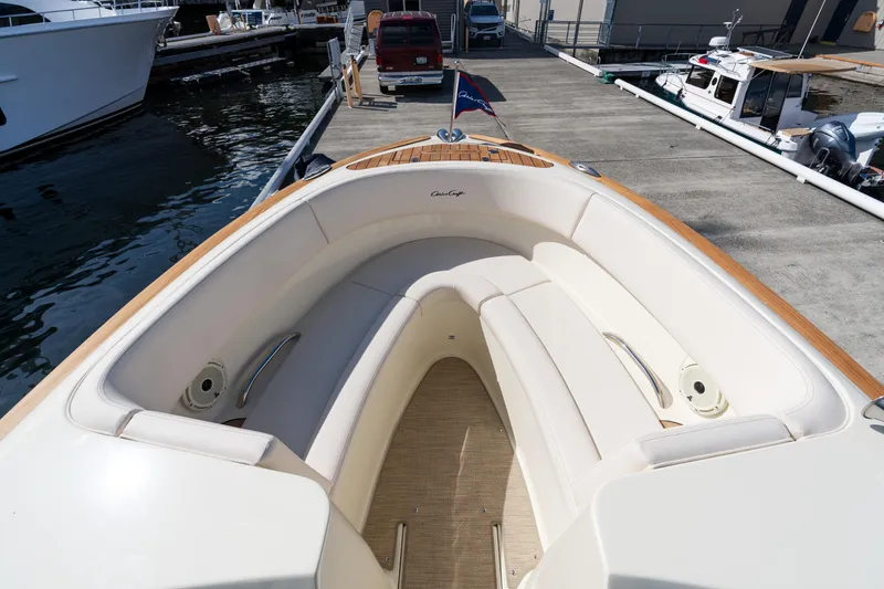 Slide: The Image of 2022 Chris-Craft Launch 27 boat with elegant seating at a marina dock. - 9