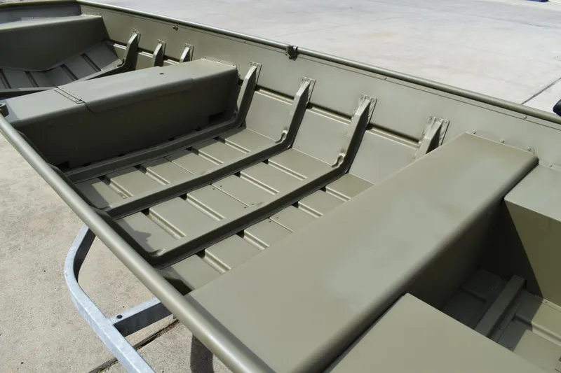 Slide: The Image of 2024 Lowe L1440M Jon boat interior with bench seats and ribbed flooring. - 6