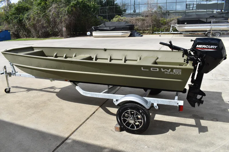 Slide: The Image of 2024 Lowe L1440M Jon boat on trailer with Mercury outboard motor. - 4
