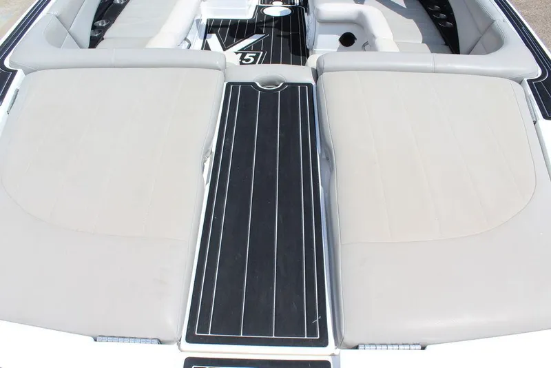 Slide: The Image of 2008 MasterCraft X45 boat interior with beige seating and black deck. - 10