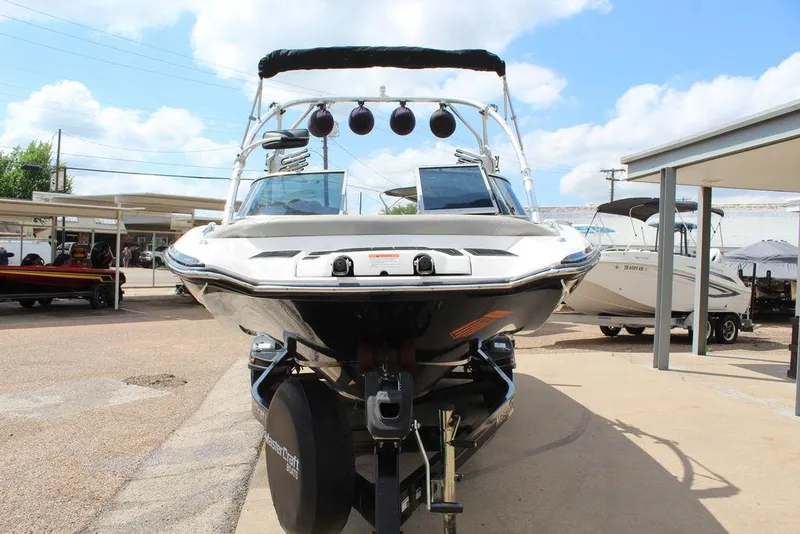 Slide: The Image of 2008 MasterCraft X45 boat on trailer, displayed outdoors under a clear sky. - 12