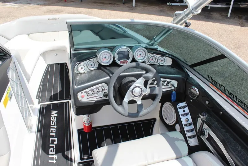 Slide: The Image of 2008 MasterCraft X45 boat dashboard with steering wheel and control gauges. - 17