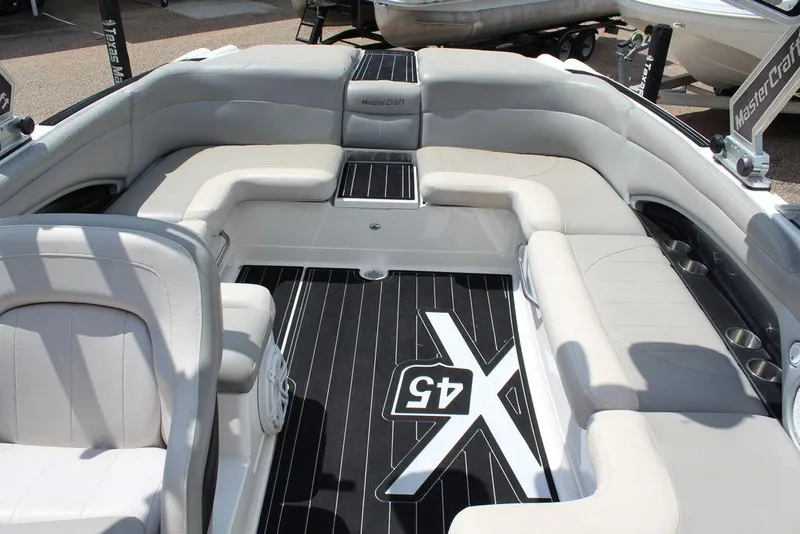 Slide: The Image of 2008 MasterCraft X45 boat interior with cushioned seating and branded flooring. - 21
