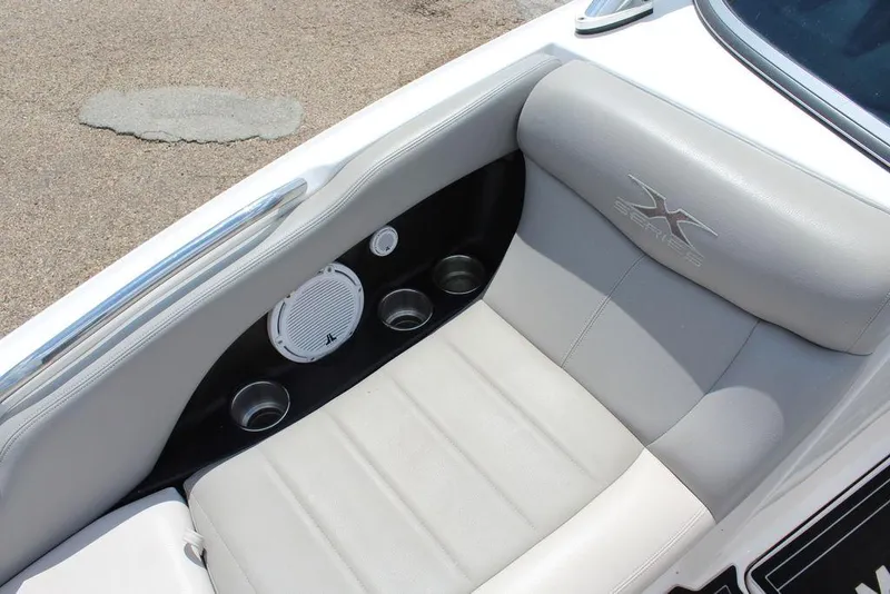 Slide: The Image of 2008 MasterCraft X45 boat interior with gray seating and built-in speakers. - 22