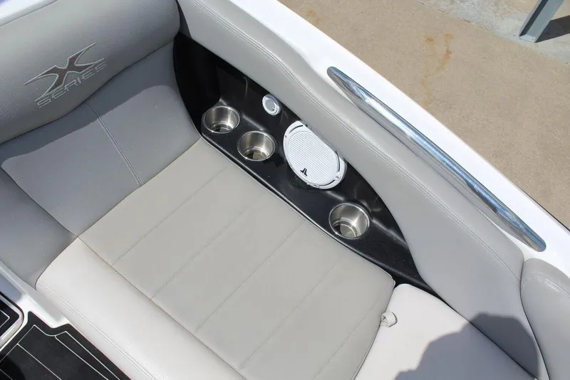 Slide: The Image of 2008 MasterCraft X45 boat interior with cup holders and speaker. - 23