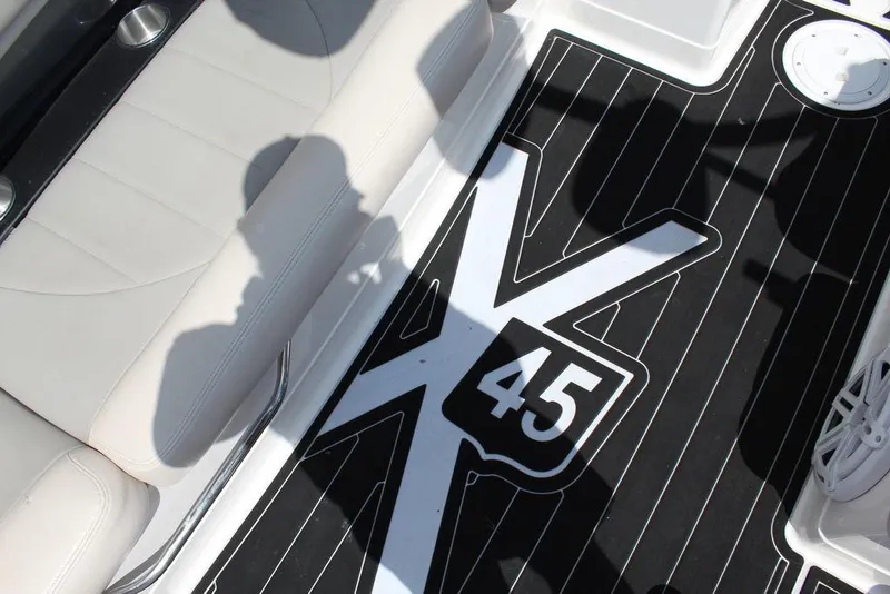 Slide: The Image of 2008 MasterCraft X45 boat interior with logo on black flooring. - 25