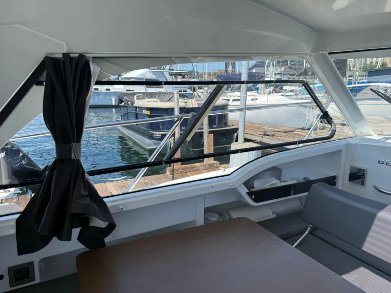 Slide: The Image of Interior view of 2021 Beneteau Antares 8 boat, showcasing dockside marina scene. - 12